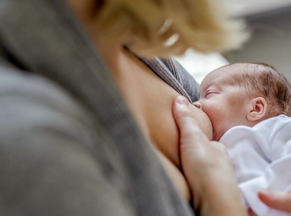 A mom breastfeeds her premature baby.