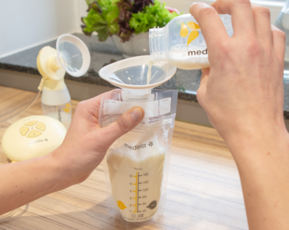 Medela breast milk storage bags filled with pumped breast milk, ready for refrigeration or freezing.