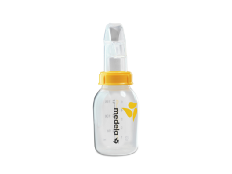 SoftCup™ An advanced cup feeder, the Medela SoftCup™. It is connected to a reusable Medela breast milk storage bottle.