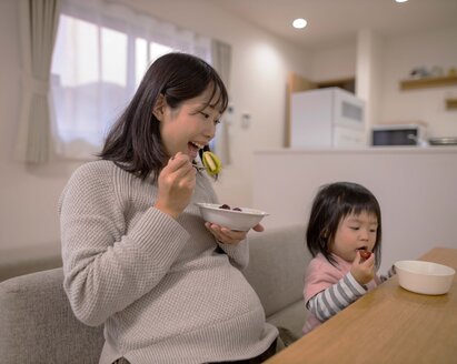 Pregnant woman enjoying a healthy meal, emphasizing the importance of nutrition during pregnancy