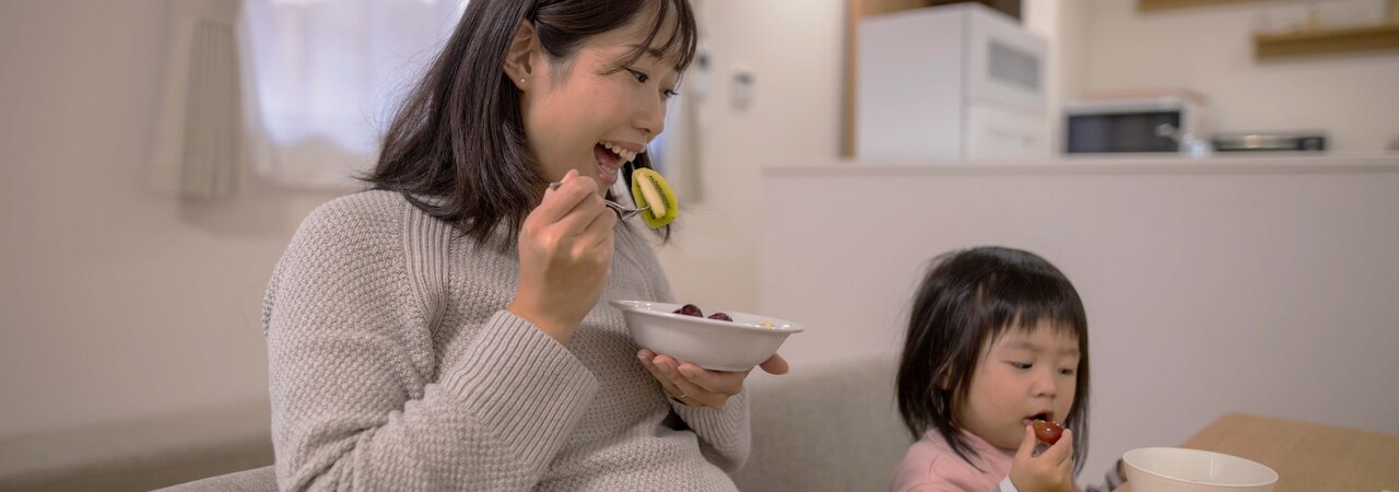 Pregnant woman enjoying a healthy meal, emphasizing the importance of nutrition during pregnancy