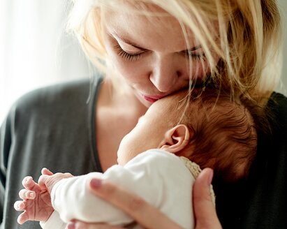 baby being burped to reduce spit-up, with helpful tips and insights from Medela